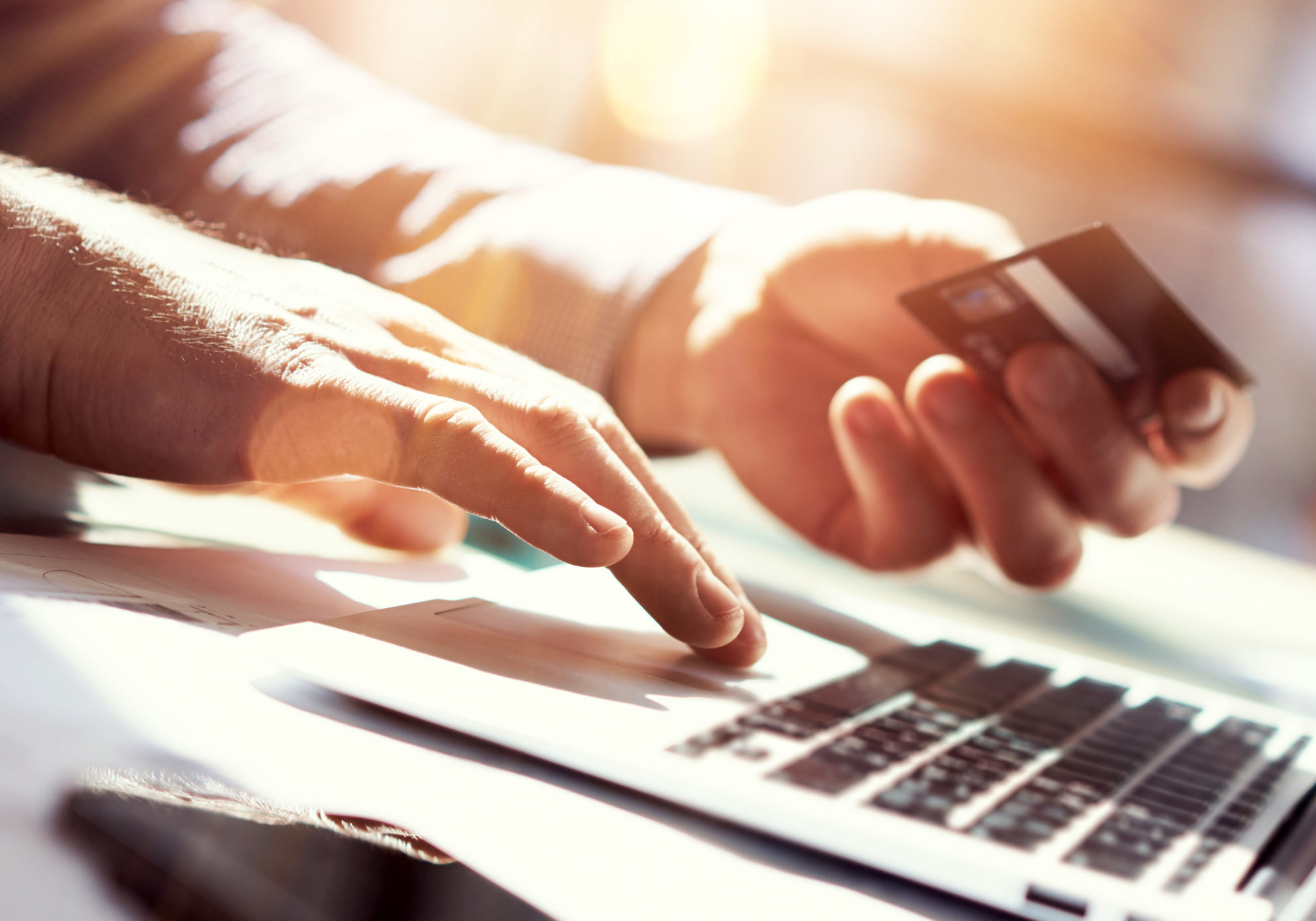 Closeup Man Holding Hand Credit Card.Businessman Use Laptop Online Payments Shopping.Guy Typing Keyboard Notebook Name Numbers Plastic Debit Kard Holder.Flares, Blurred Background